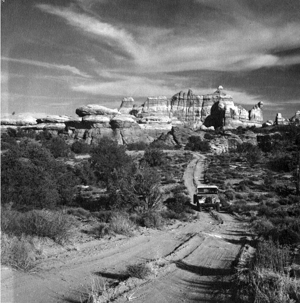 Image P1286n18 from the Kent Frost Collection. Jeep in Chelser Park, Canyonlands National Park. 1962. Photograph by Earl T. Van Pelt Jeep in Chelser Park, Canyonlands National Park. 1962. Photograph by Earl T. Van Pelt
