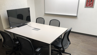 table, 2 chairs, whiteboard, and projector screen