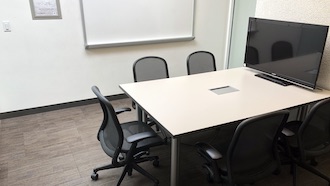 table, 2 chairs, whiteboard, and projector screen