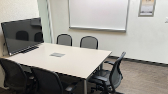 table, 2 chairs, whiteboard, and projector screen