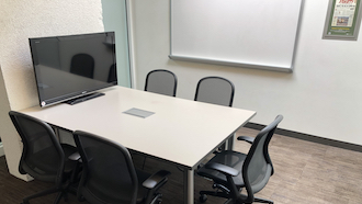 table, 2 chairs, whiteboard, and projector screen