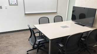 table, 2 chairs, whiteboard, and projector screen