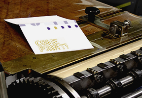 image of letterpress-printed card on a press feed board