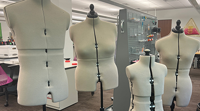 Four fabric dress forms of various sizes