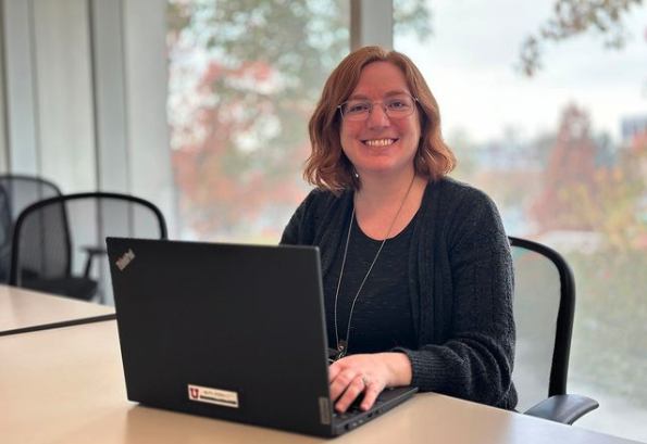 Annika Deutsch, librarian sitting cheerfully at a laptop