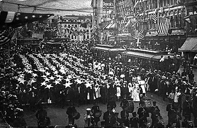 Marchers carrying stars and colored material to make stripes for a flag in a statehood parade in Salt Lake City, 1910. Photo from the University of Utah Marriott Library.