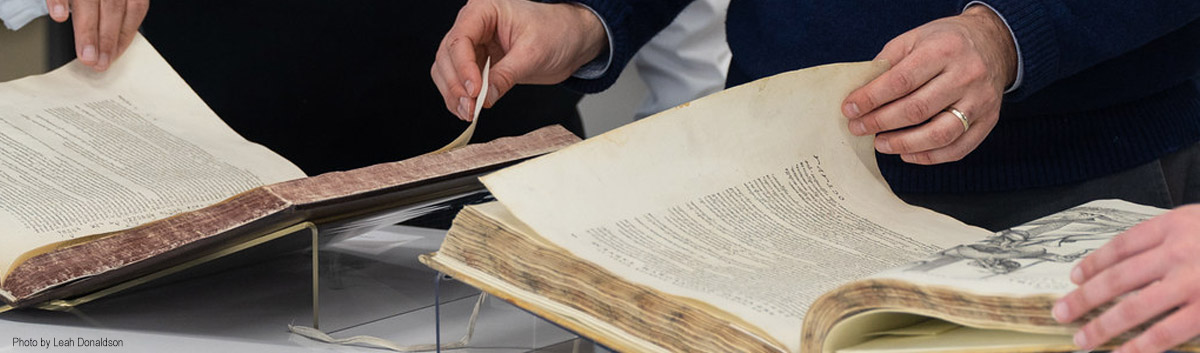 hands turing the pages of old books