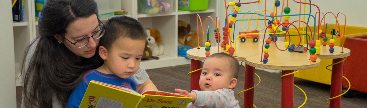 Photo of mom, son, and baby in the Marriott Library Family Reading Room