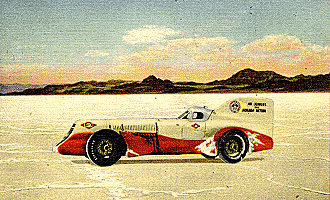 A postcard depicting a vintage red and white race car parked in a vast, sunlit desert landscape with salty dunes and a clear blue sky