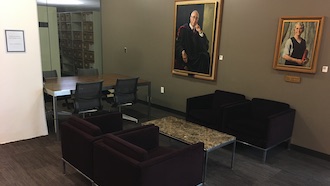 4 soft seating chairs around a coffee table next to 4 active seating chairs around desk height table